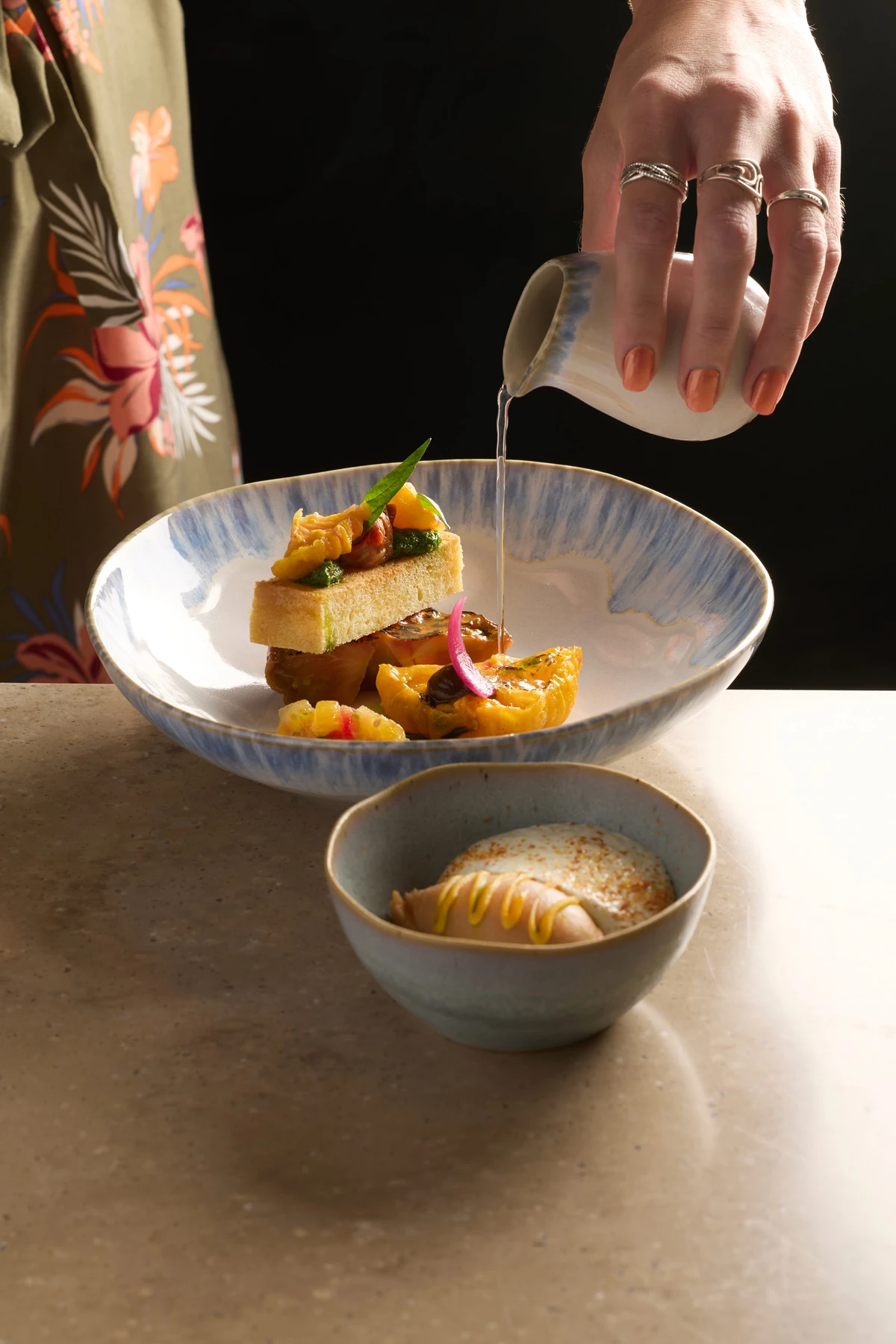 Une sauce versée au service sur une assiette du chef